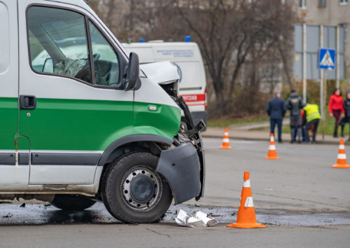 Heavily damaged car after car crash accident on a city street.